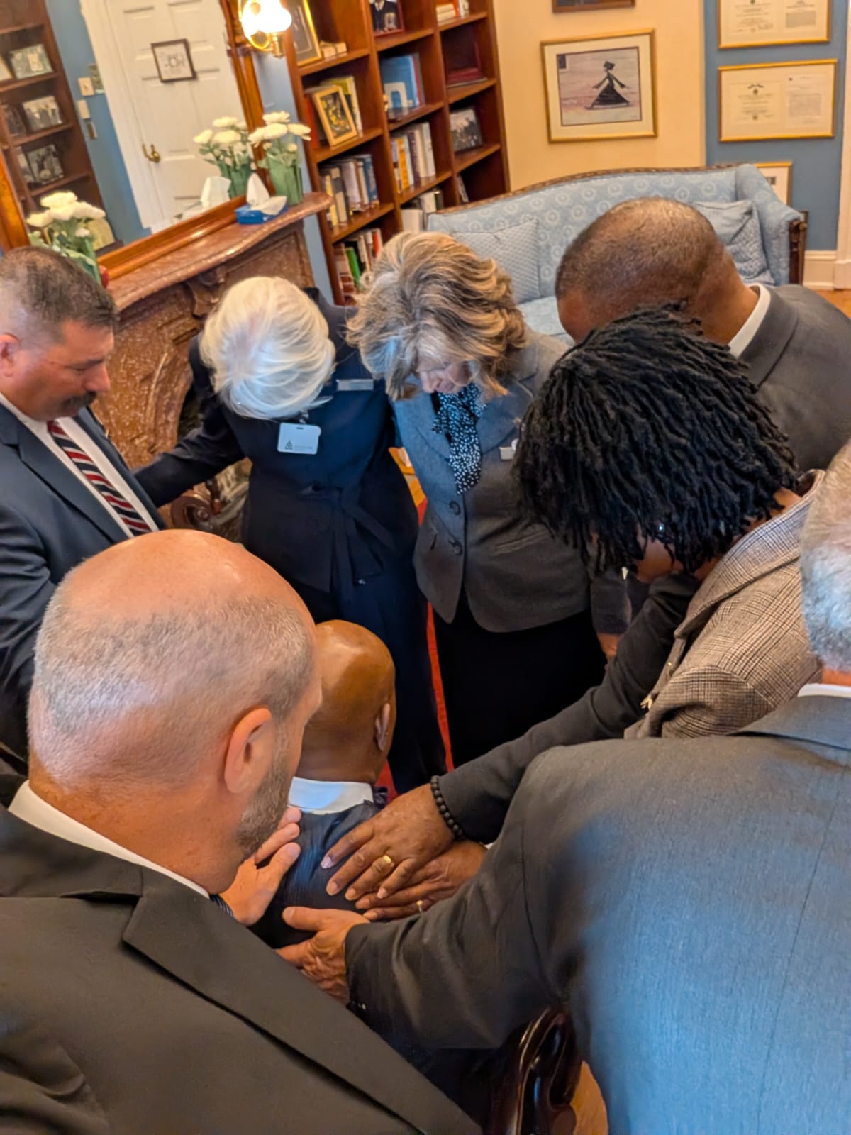The team praying for Senate Chaplain Barry Black